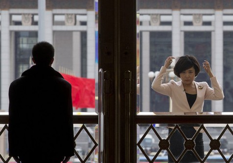 2014年兩會：美女記者對窗梳妝 黑衣保安不為所動(dòng)