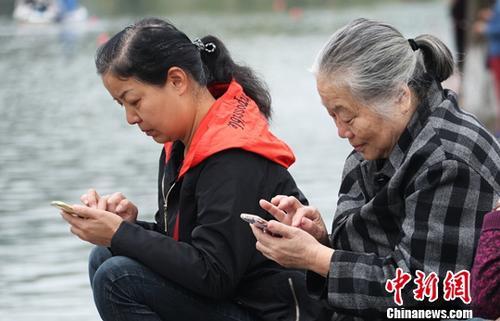 圖為中國中老年女性使用智能手機上網。(資料圖) 劉占昆 攝